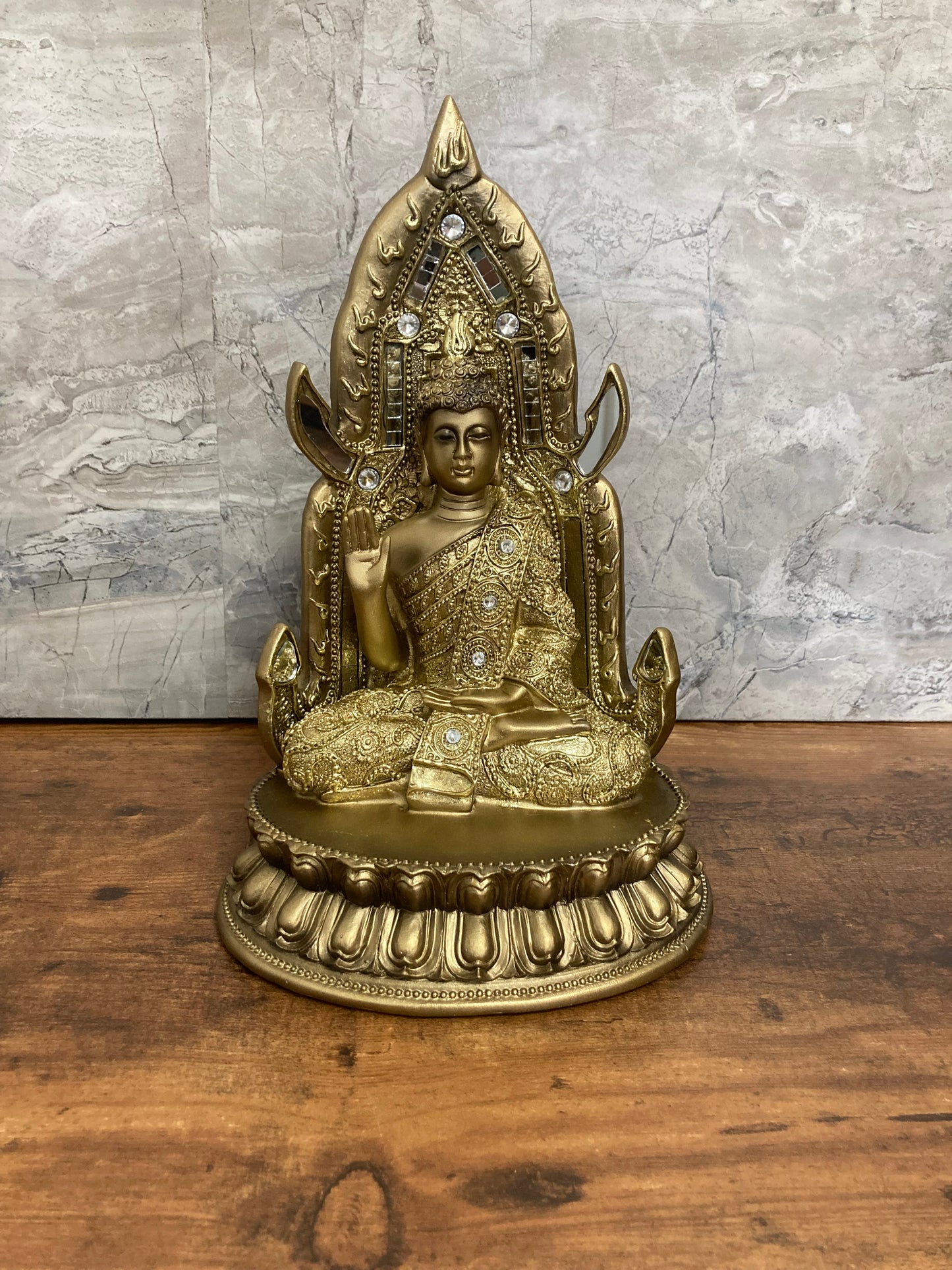 Golden Buddha statue meditation faith with stones and mirrors.