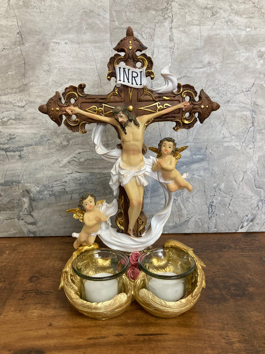 Figurine Cross Jesus table top with angles and candles . Home decor .