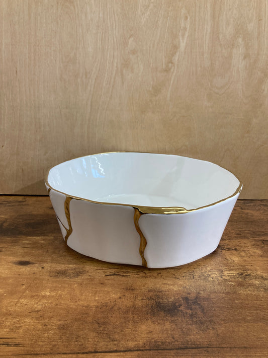 Serving white ceramic Salad fruit bowl round with gold color pattern. Home decor table top.
