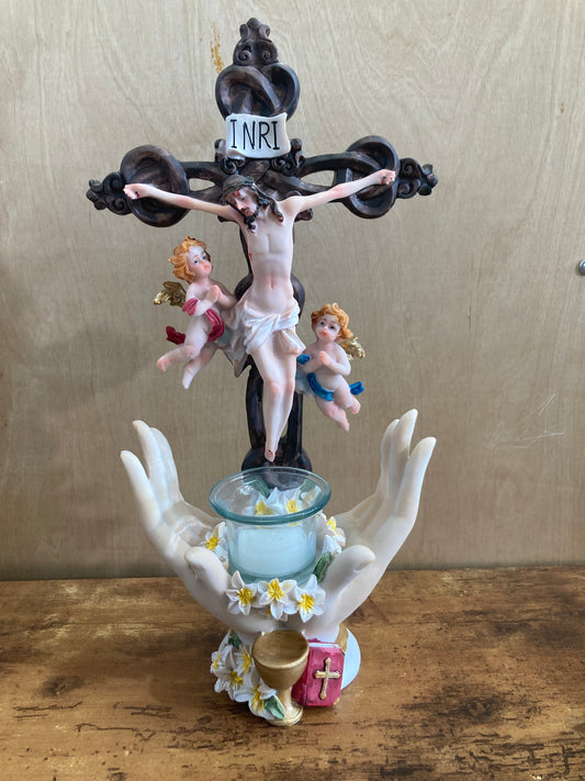 Figurine Cross Jesus table top with angles and candle . Home decor .
